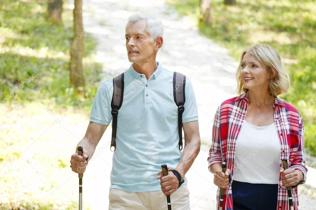 Active senior couple walking  in the forest