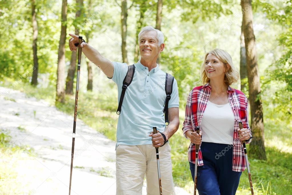 Active senior couple walking  in the forest