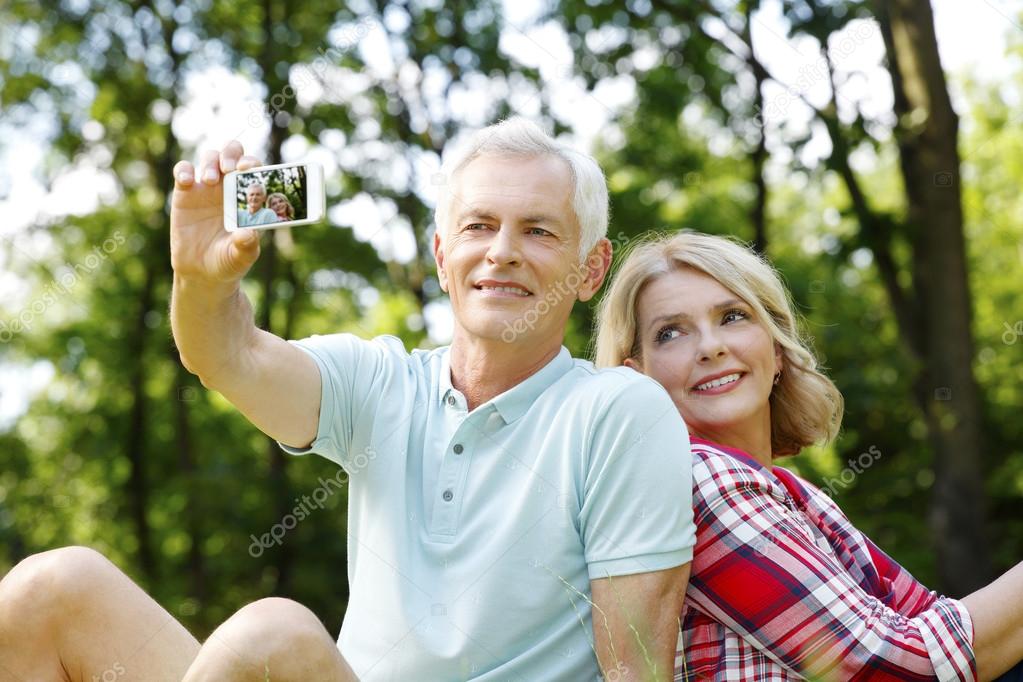 Senior couple taking selfies 