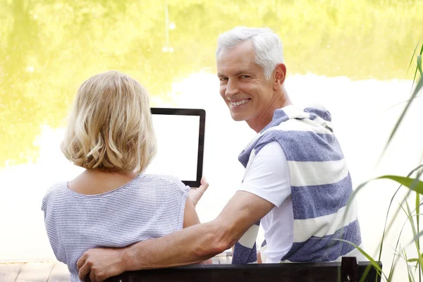 Senior couple with digital tablet — Stock Photo, Image