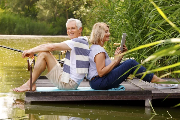 Senior couple sitting at the pier