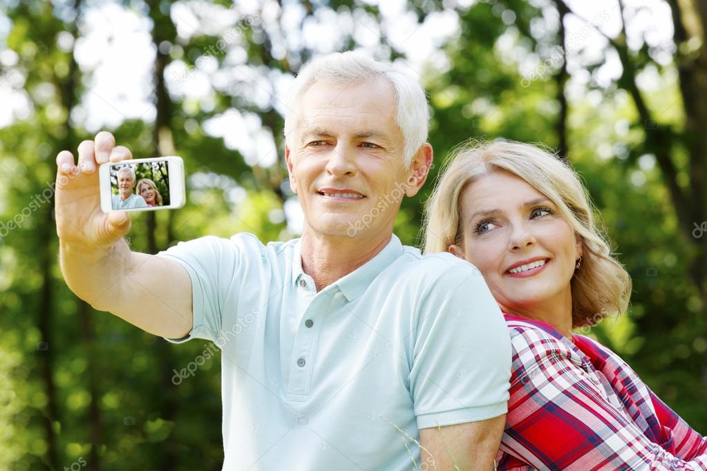 Senior couple taking selfies