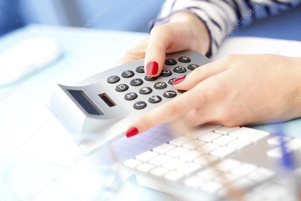 Businesswoman using calculator 