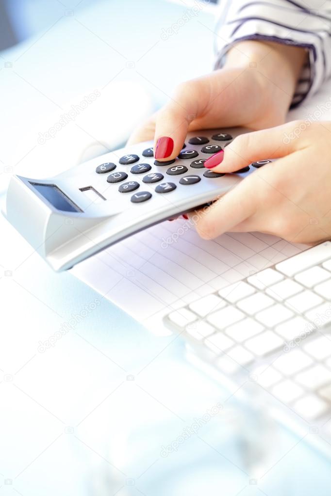 Businesswoman using calculator 