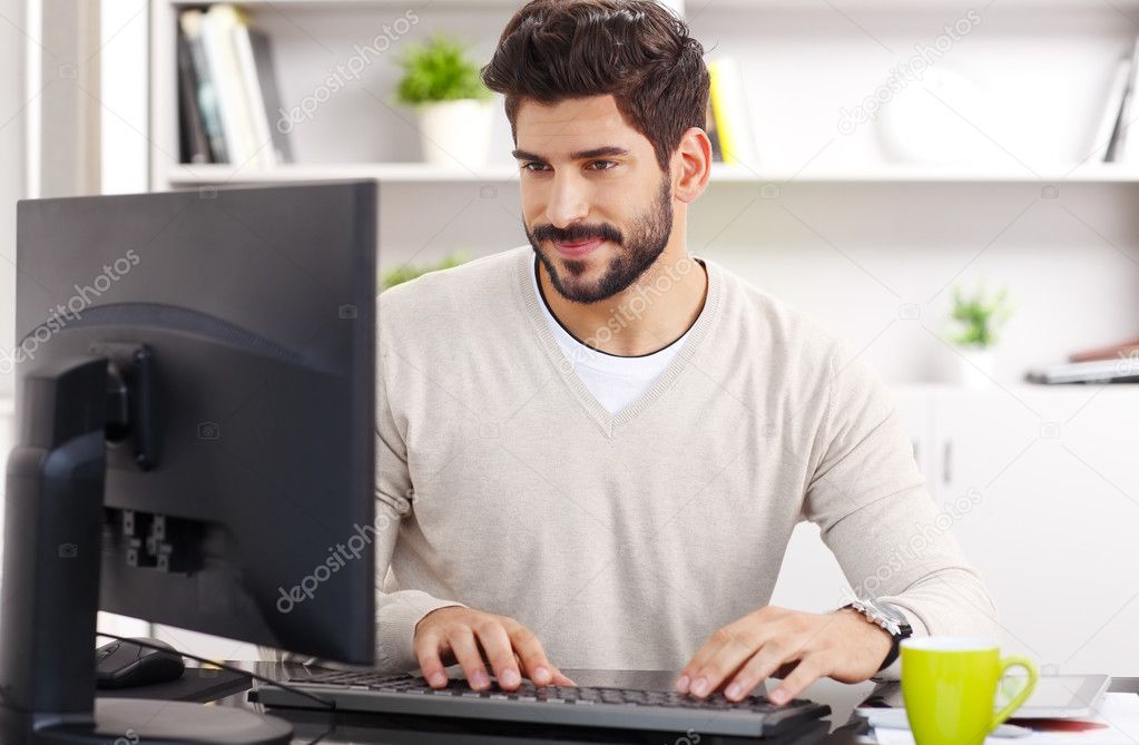 Young businessman sitting at workplace