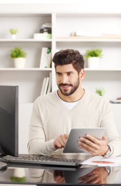 Young professional touching digital tablet