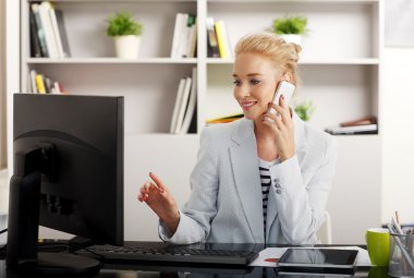 Businesswoman making a call at office
