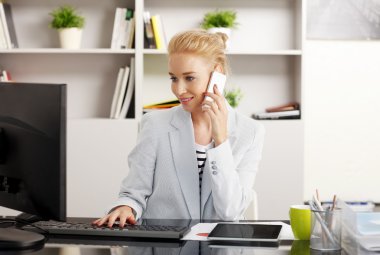 Businesswoman making a call at office
