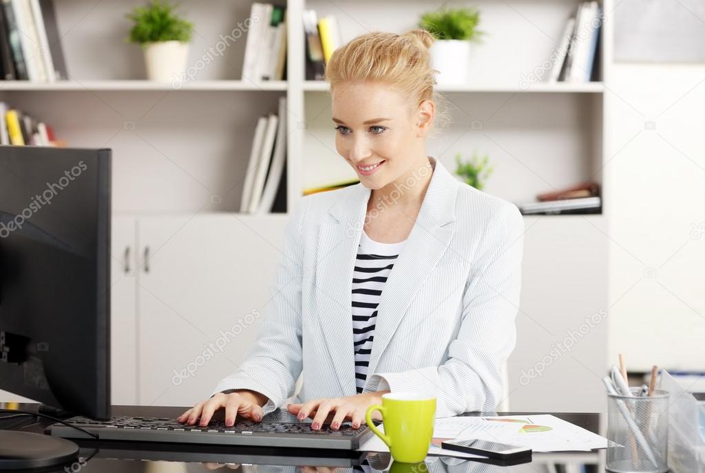 Young businesswoman working on presentation at office.