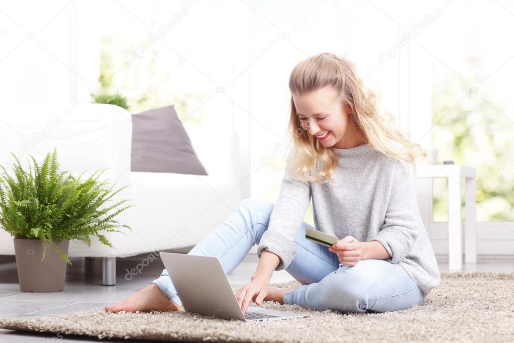 Smiling woman paying bills online