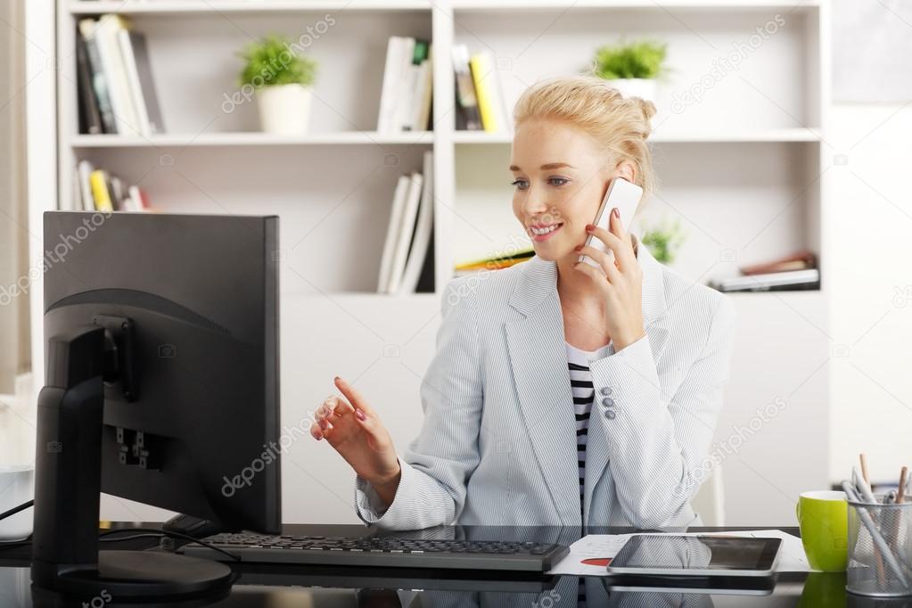 Businesswoman making a call at office