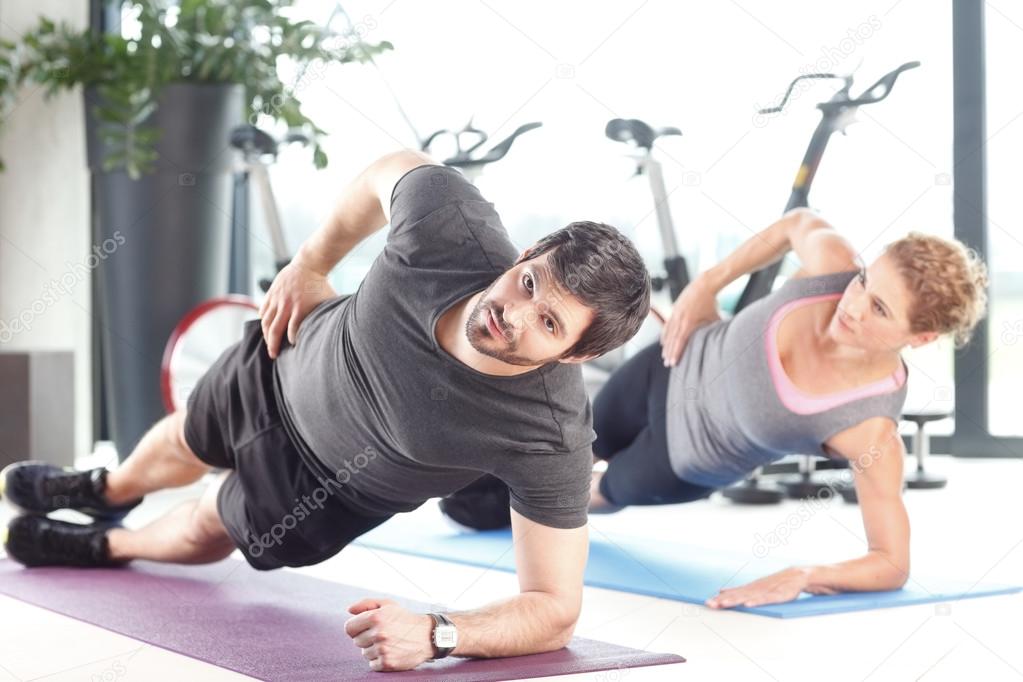 Man and a woman doing plank exercises
