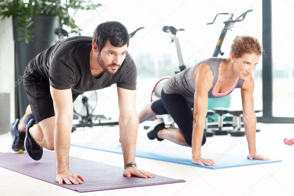 Man and woman doing plank exercises