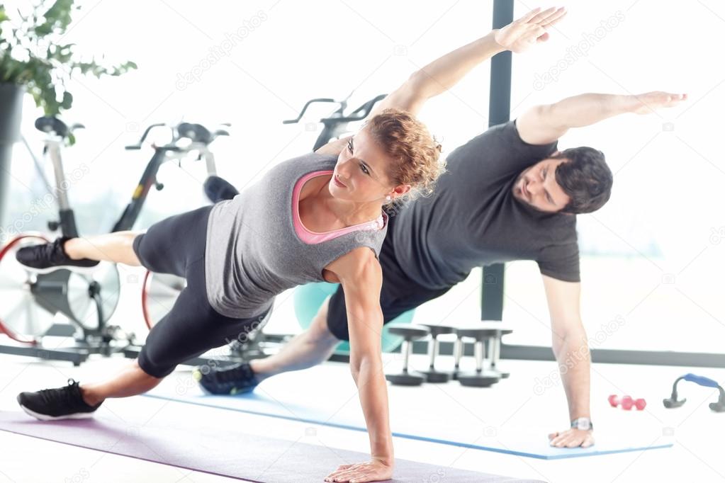 Man and woman doing plank exercises