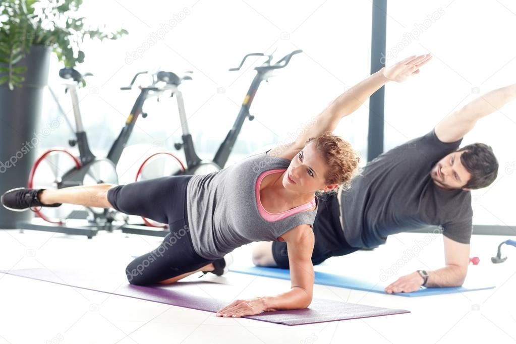 Man and woman doing plank exercises