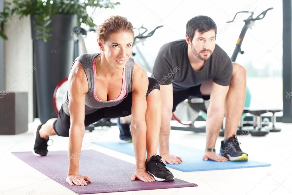 Man and woman working out at the gym