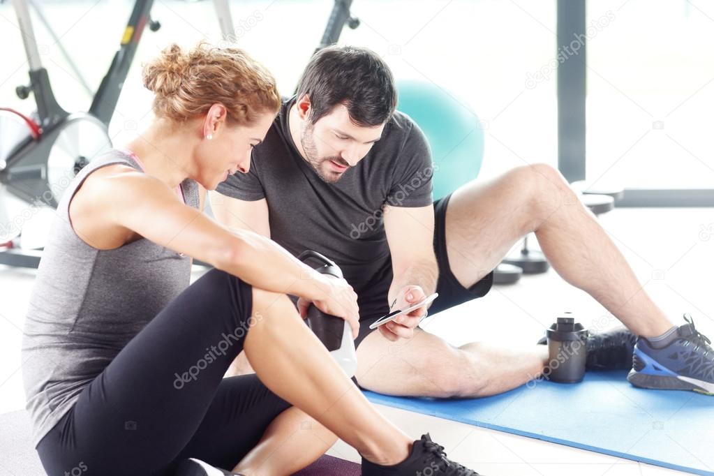 People taking a break after a workout at the gym