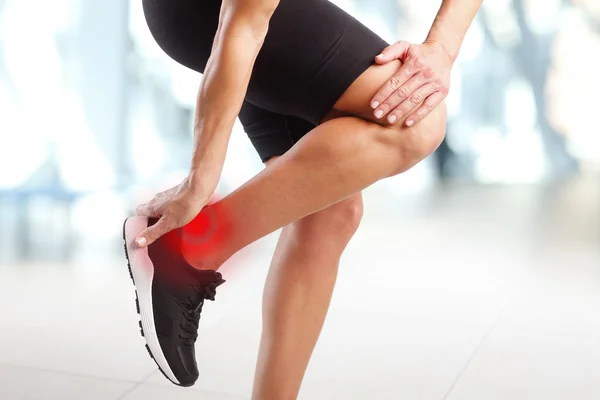 Ankle in pain at workout at the gym — Stock Photo, Image