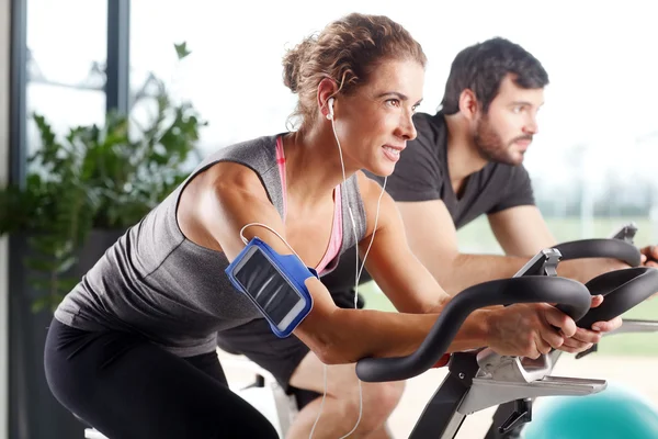 Gym members participating in a spinning class