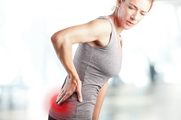 Mulher sentindo dor na parte inferior das costas Fotografias De Stock Royalty-Free