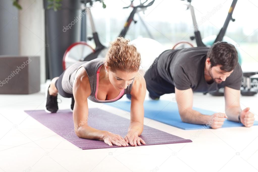Man and woman training together at the gym