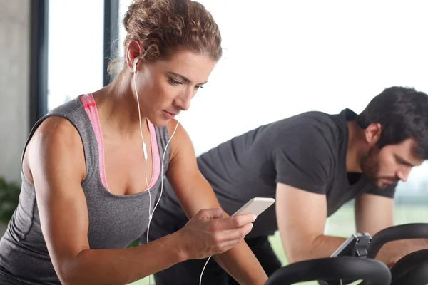 Gym members participating in a spinning class