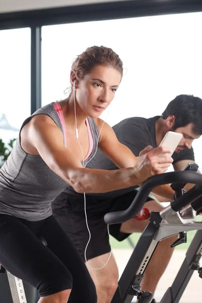 Gym members participating in a spinning class