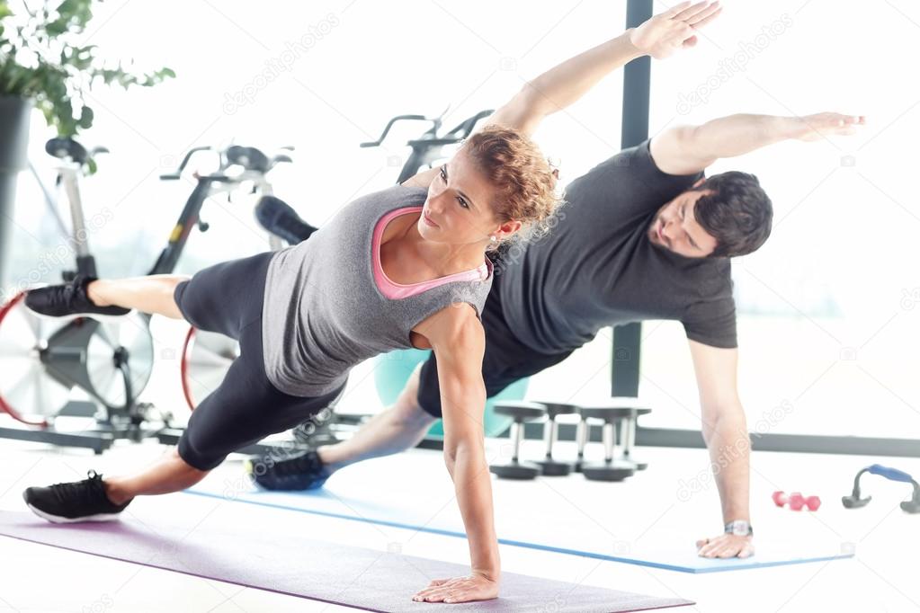 Man and a woman doing plank exercises
