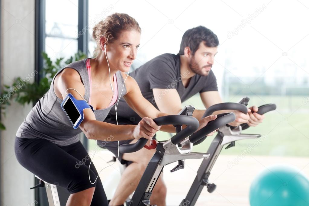 Gym members participating in a spinning class