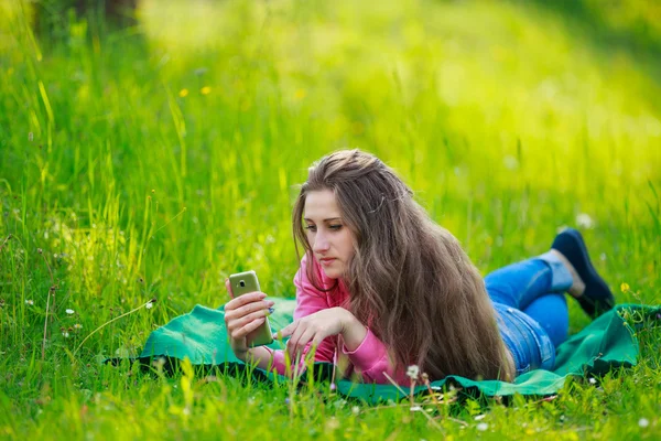 Vrouw met telefoon liggen — Stockfoto