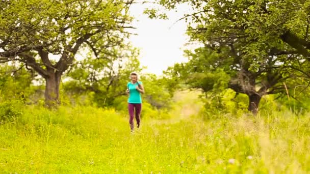 Chica con auriculares corriendo — Vídeos de Stock