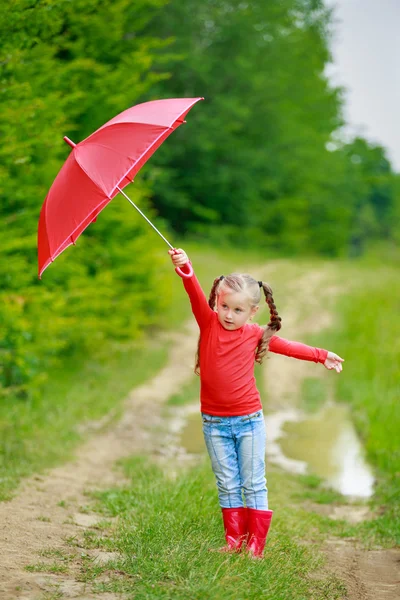 Little girl with red umbrella — Stock Photo, Image