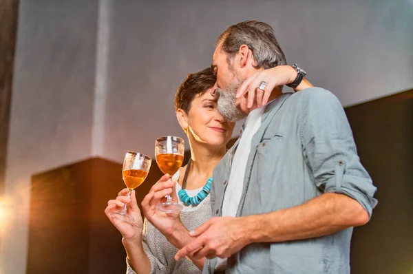 Aged couple with glasses of wine — Stock Photo, Image