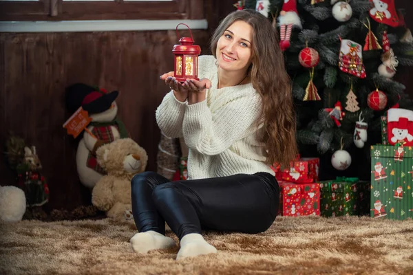 Girl with a small flashlight in her hands — Stock Photo, Image