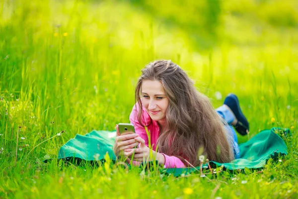 Girl with a phone in her hands — Stock Photo, Image