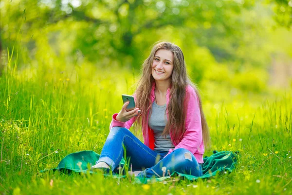 Girl with a phone in her hands — Stock Photo, Image