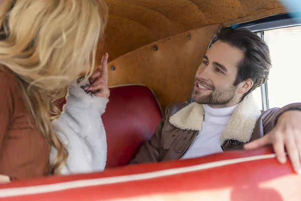 couple sitting in the back seat of a car