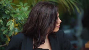 Masada takım elbiseli güzel bir kadın oturuyor.