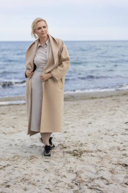 Deniz kenarındaki ceketli kadın.