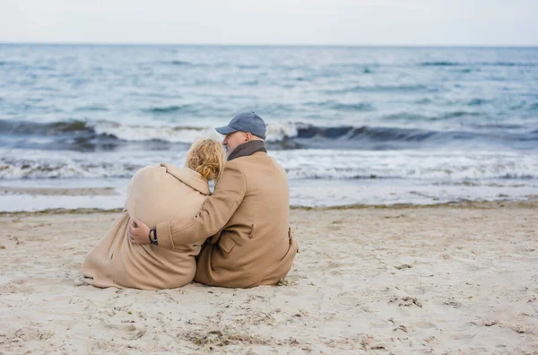 W wieku para siedzi na plaży — Zdjęcie stockowe