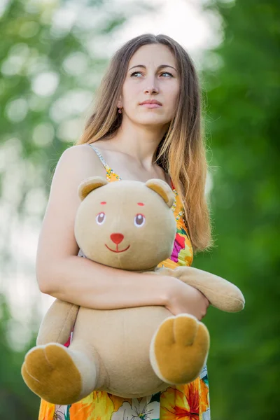 Woman with teddy bear — Stock Photo, Image