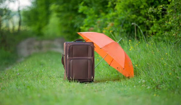Чемодан с зонтиком — стоковое фото
