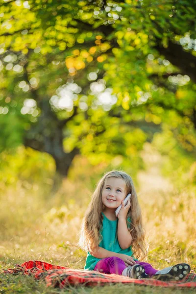 Little girl with a phone — Stock Photo, Image