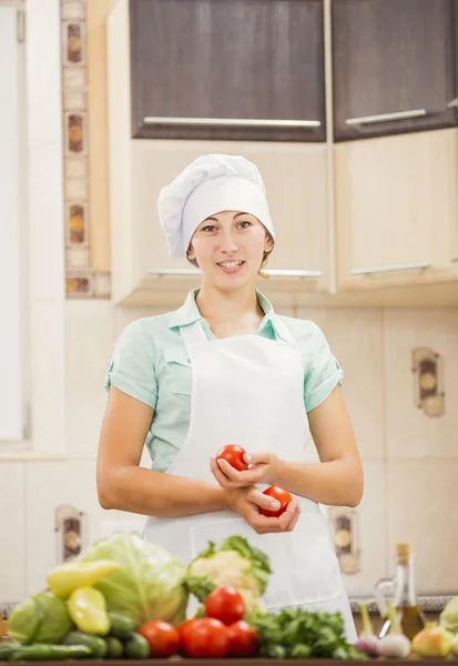 Girl cook with tomatoes in hands — Stock Photo, Image