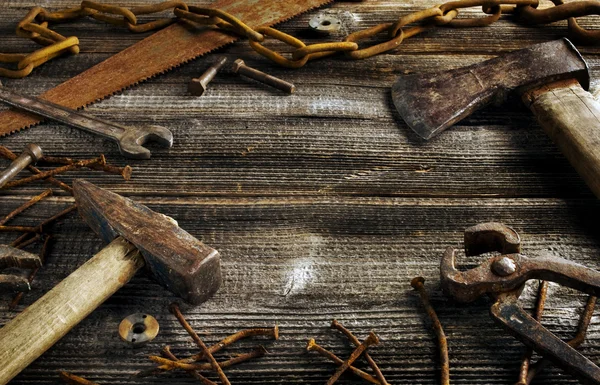Rostiga verktyg på gamla mörk planka — Stockfoto