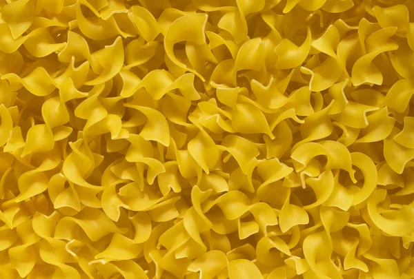 Tagliatelle mosse tészta háttér — Stock Fotó