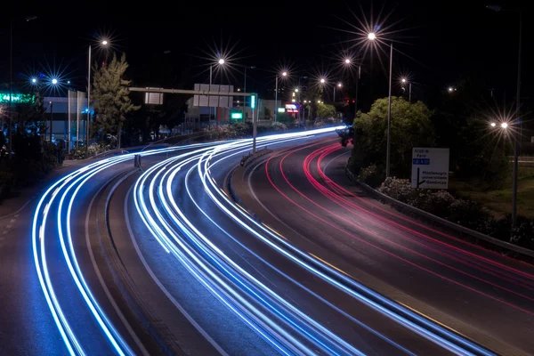 Car streak lights at night near the airport of Faro city — Stock Photo, Image