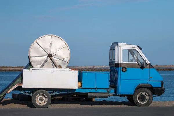 small truck that transports a fishing net