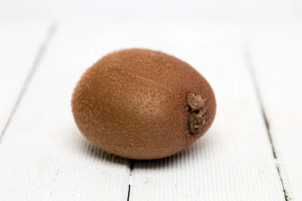 Tasty kiwi fruit isolated on a white wooden background. — Stock Photo, Image