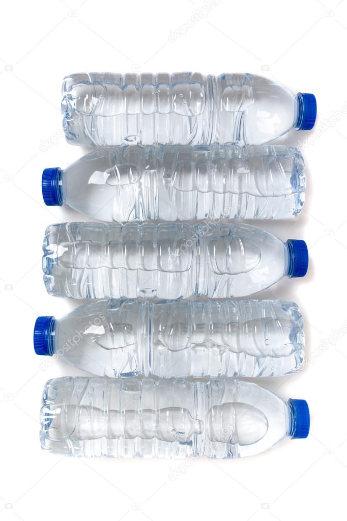 Row of plastic water bottles isolated on a white background.